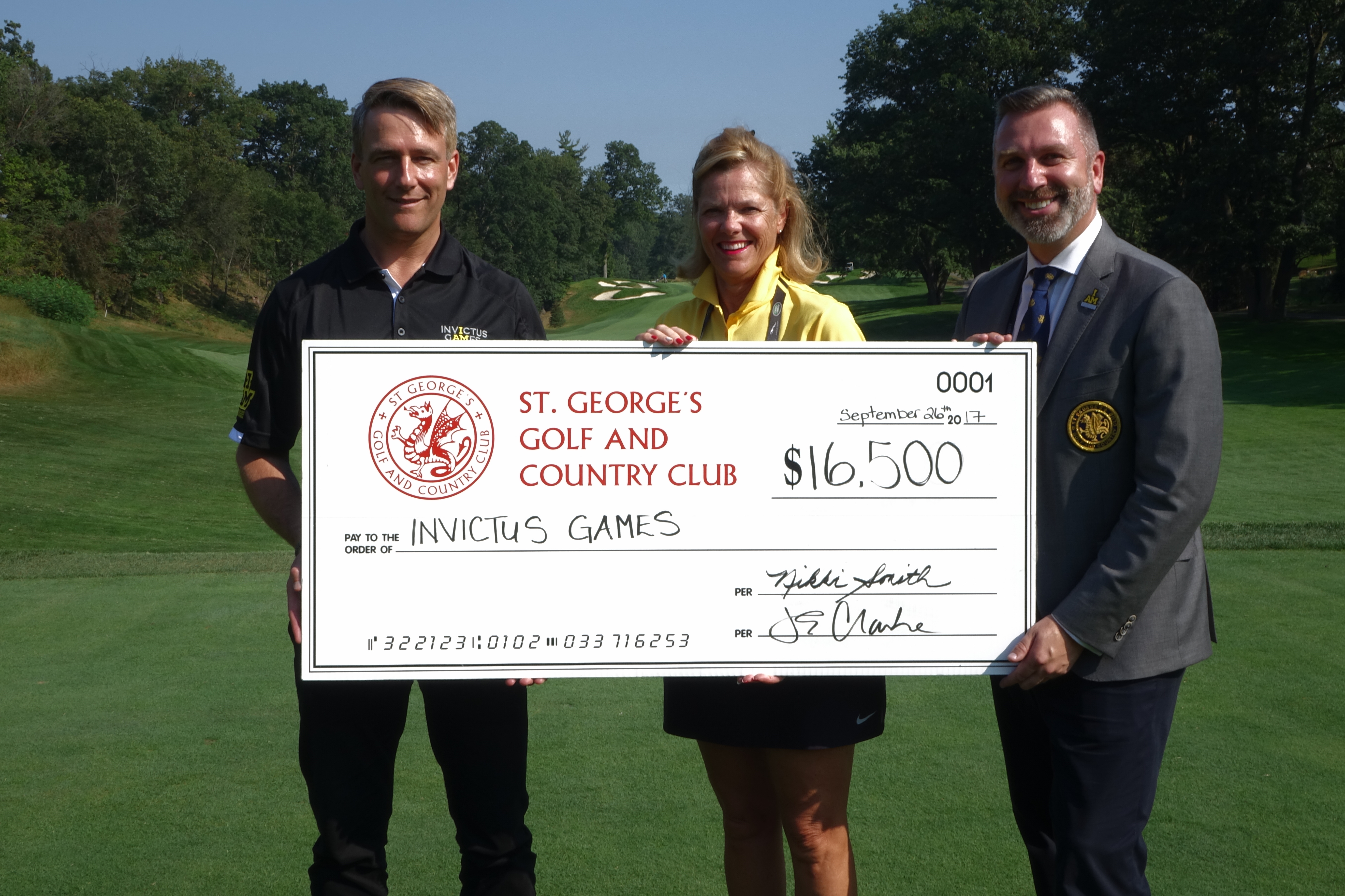 St. George's presents Invictus CEO, Micheal Burns with $16,500 raised in support of the Invictus Games and True Patriot Love Foundation.